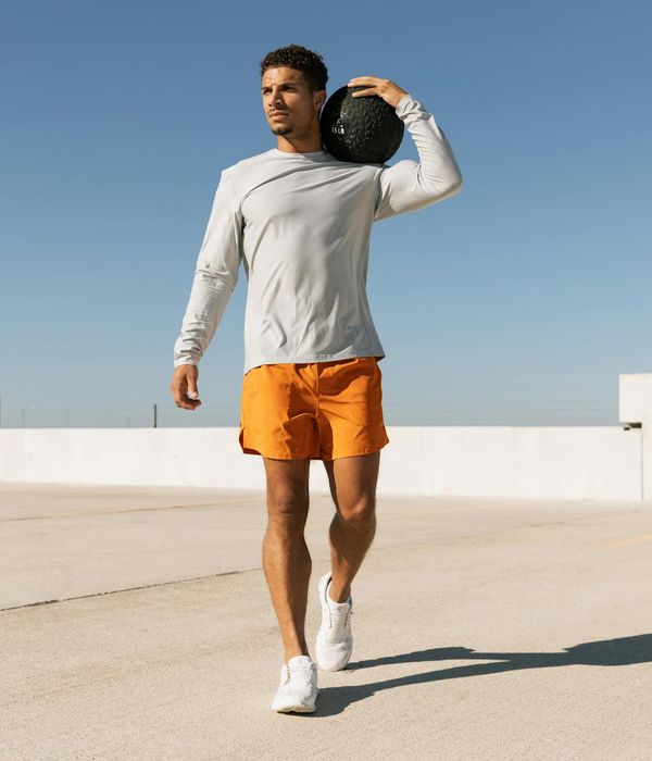 A man performing a bodyweight strength exercise in a modern gym.